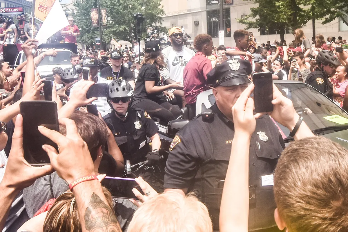 LeBron James rides through crowds of fans at the Cavaliers' championship parade in Cleveland, June 2016